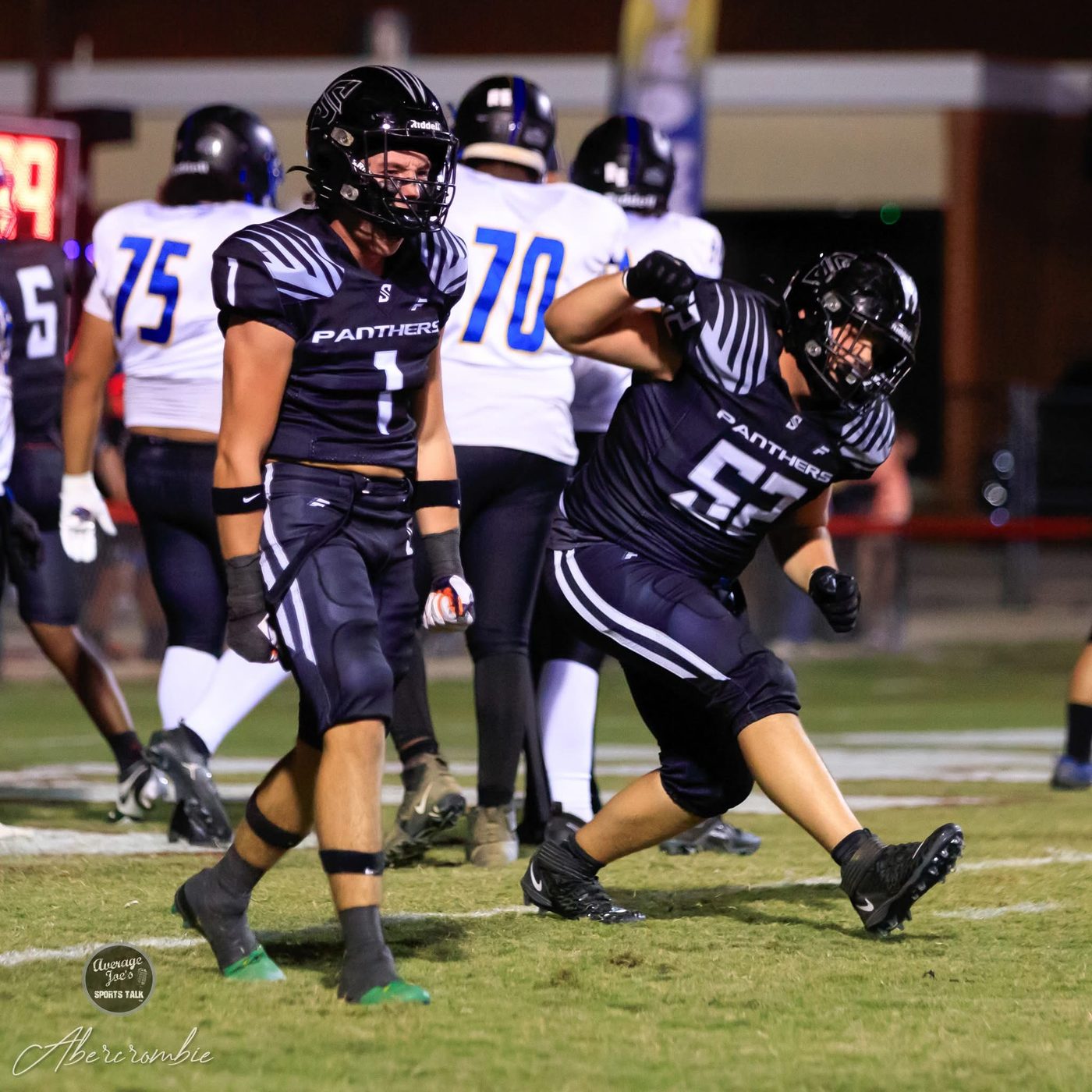 Two Panther players celebrating a defensive stop